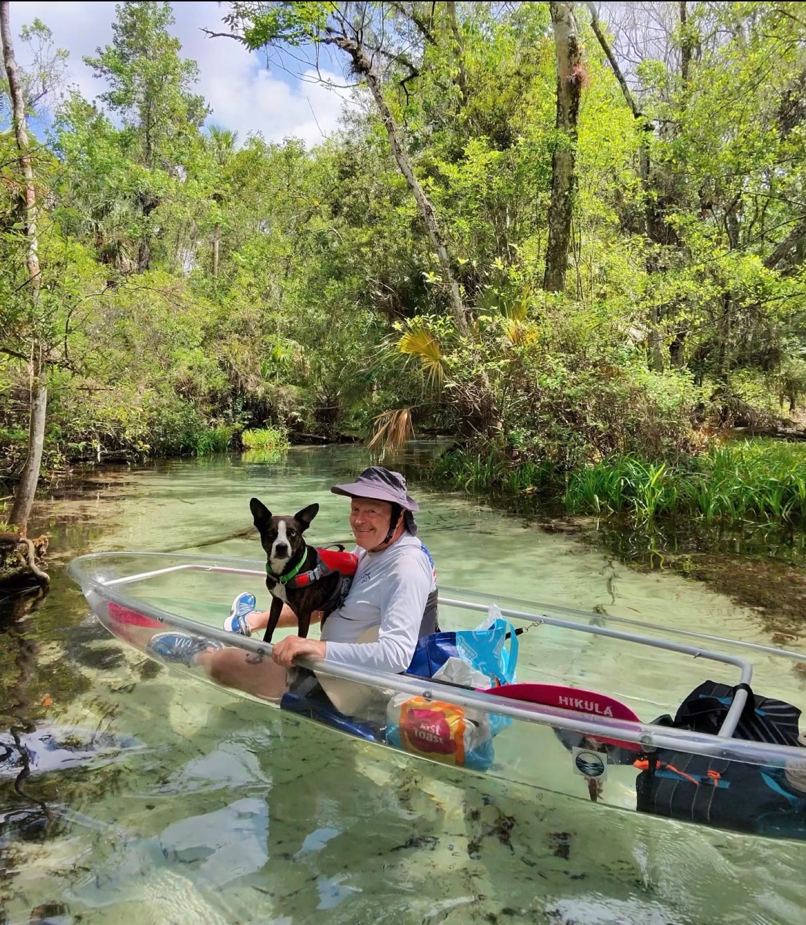 A guest paddling a single clear kayak on a Florida spring run